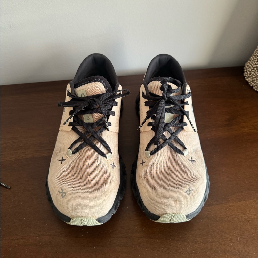 On Running Cream and Black Athletic Shoes